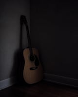 Art as an outlet a guitar in a dark corner